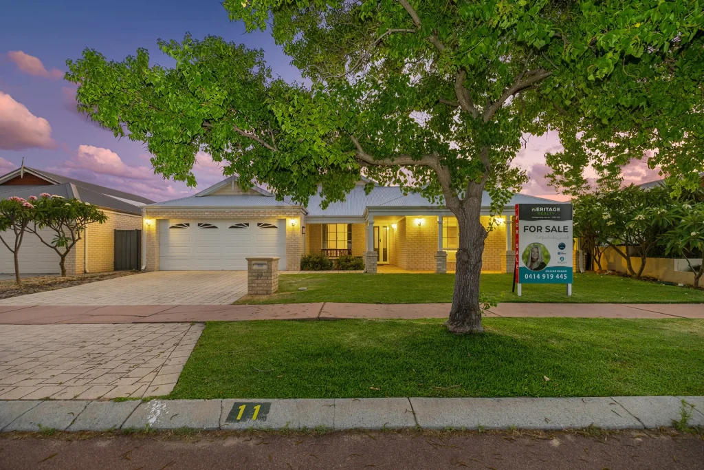 Sold sign featuring Gillian Ragan in front of a Harrisdale home