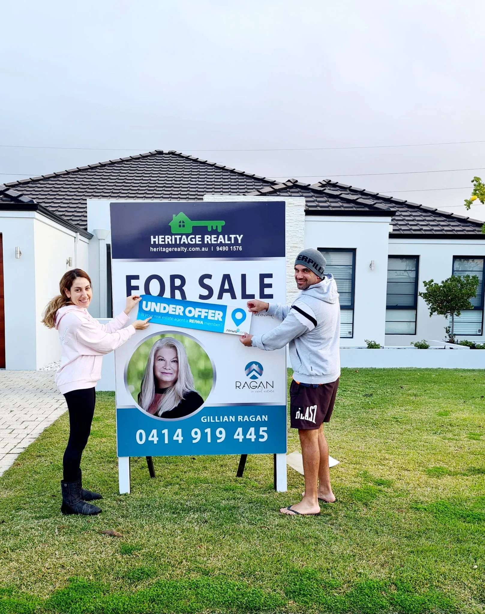 Gillian Ragan celebrating with happy property sellers